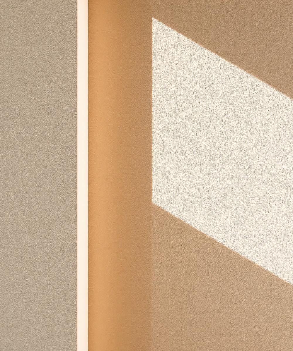 Smooth troweled stucco finish in warm light